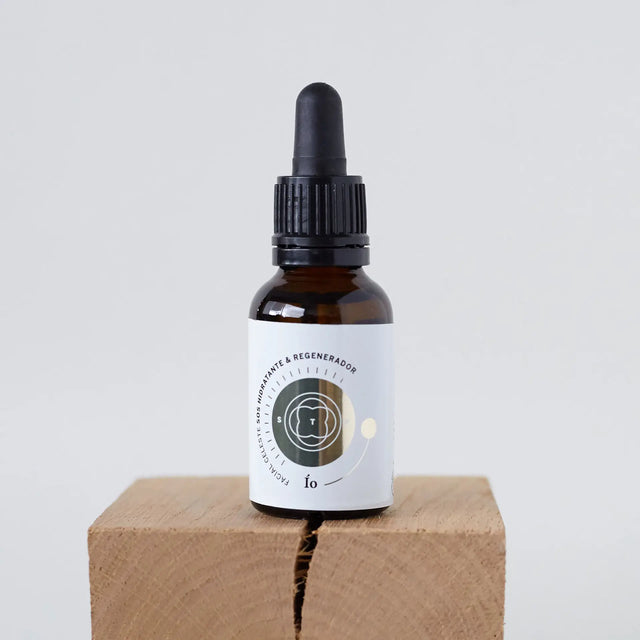 Suero facial regenerador Elixir IO en gotero de vidrio ámbar con etiqueta minimalista.