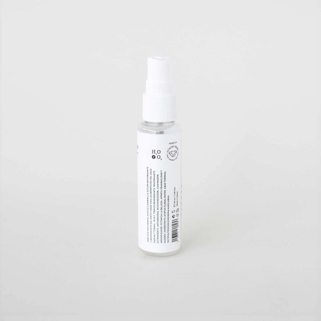 Botella pulverizadora pequeña y transparente (formato de viaje) de 'BE THERMAL' de la marca SEASKIN, con una etiqueta blanca y negra. El envase se presenta sobre un fondo blanco liso.